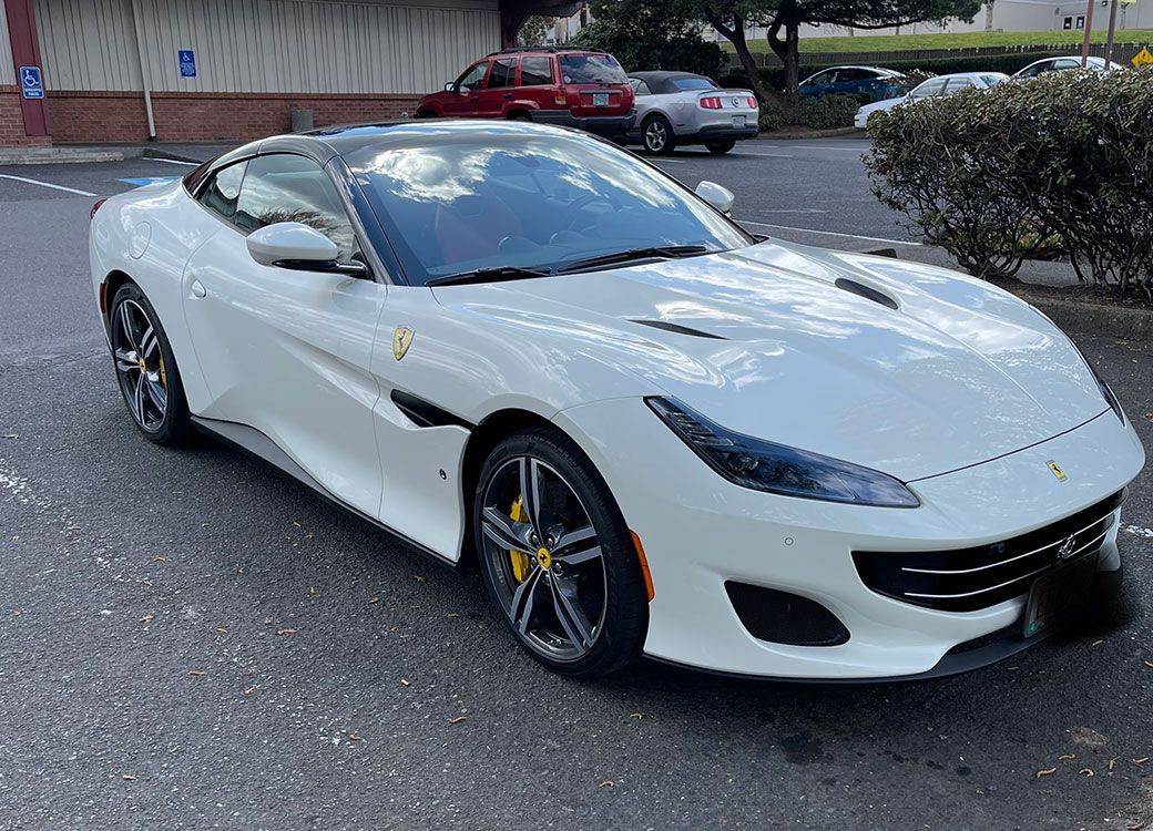 White Ferrari Portofino with a glossy ceramic coated finish outside Custom Details in Portland
