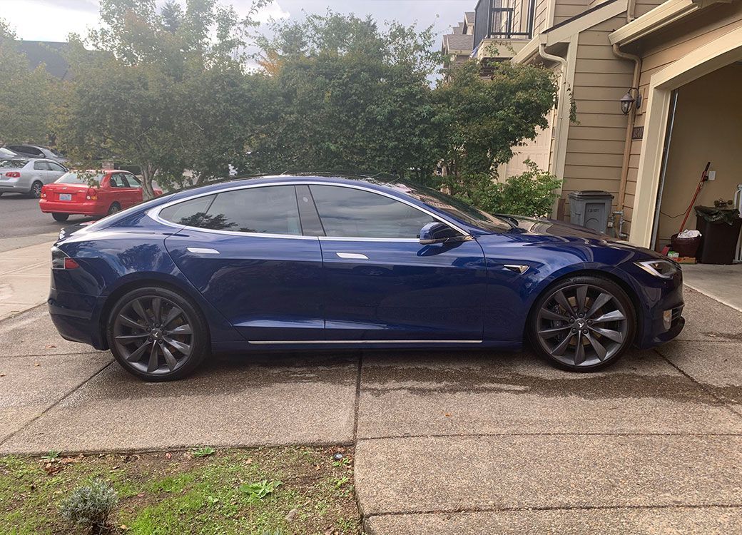Blue Tesla Model S detailed at Custom Details in Portland, parked in a driveway