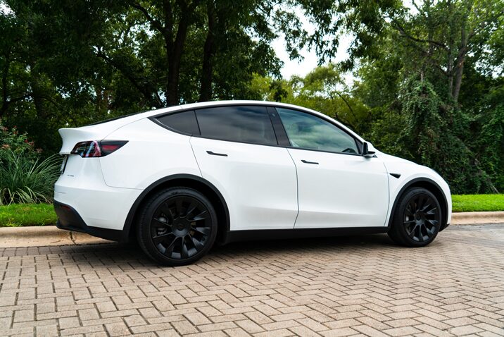White Tesla Model Y with satin black chrome delete on the window trim, door handles and badges at Custom Details in Portland